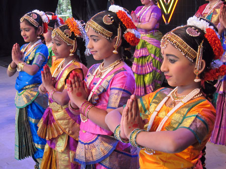 Ladies in costumes performing prayers