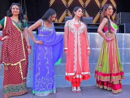 Ladies in different costumes in a line